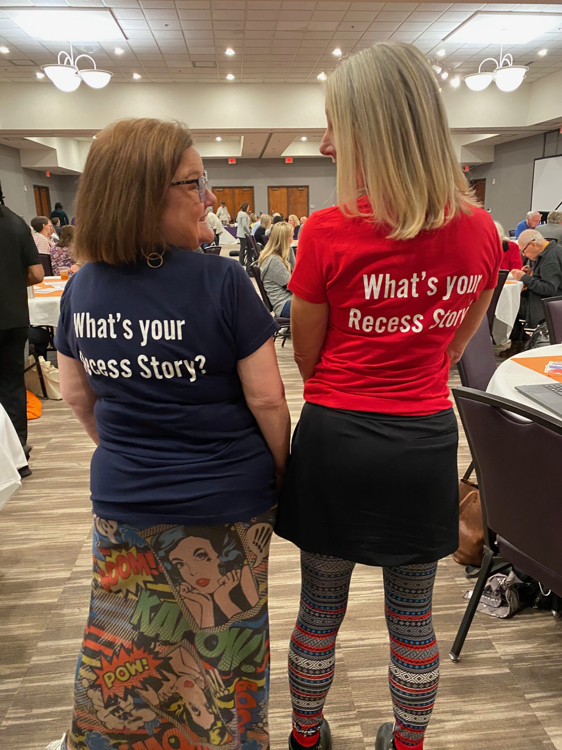 Pic of Cathy and Charlene with tshirts that say What's Your Recess Story?